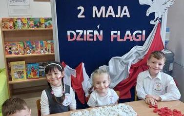2 Dzieci ukladją flagę z nakrętek